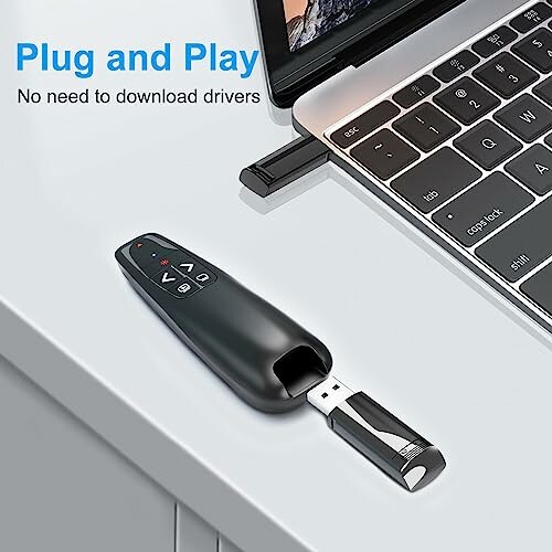 USB wireless presenter on desk next to laptop